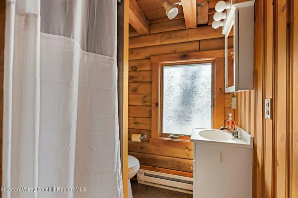 a bedroom with a bed next to a window