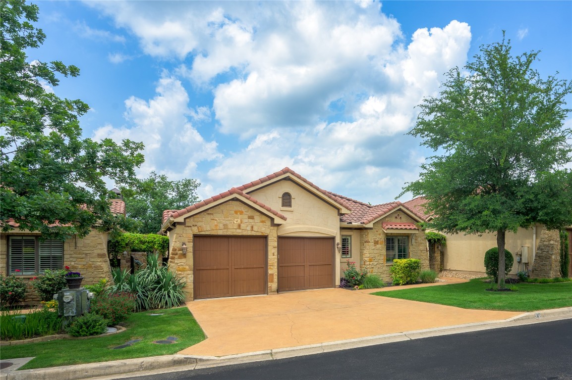 a front view of a house with a yard and garage