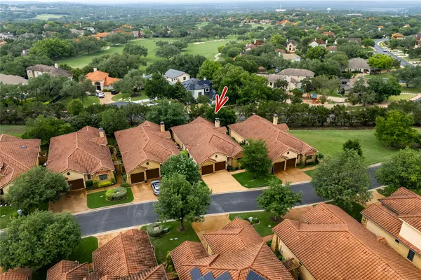 an aerial view of residential houses with outdoor space and river