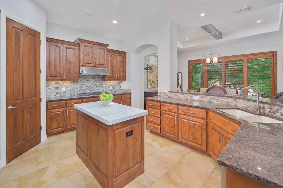 22 Borello Drive Austin, TX 78738 - Photo 11 of 26 a kitchen with stainless steel appliances granite countertop a stove a sink and a refrigerator