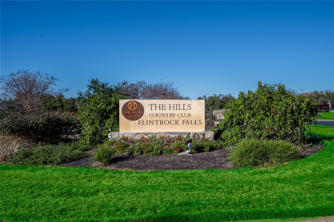 22 Borello Drive Austin, TX 78738 - Photo 24 of 26 a sign of golf club on a wall under a large tree
