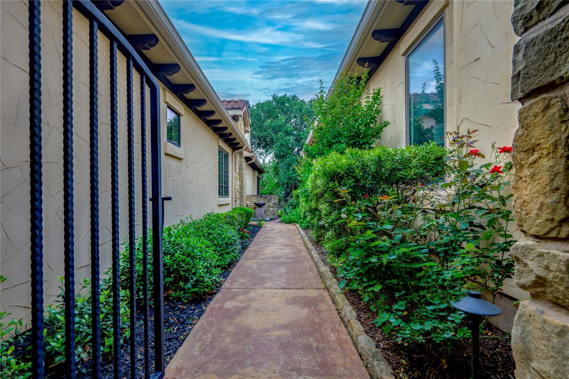 22 Borello Drive Austin, TX 78738 - Photo 8 of 26 a view of a pathway of a house with flower plants