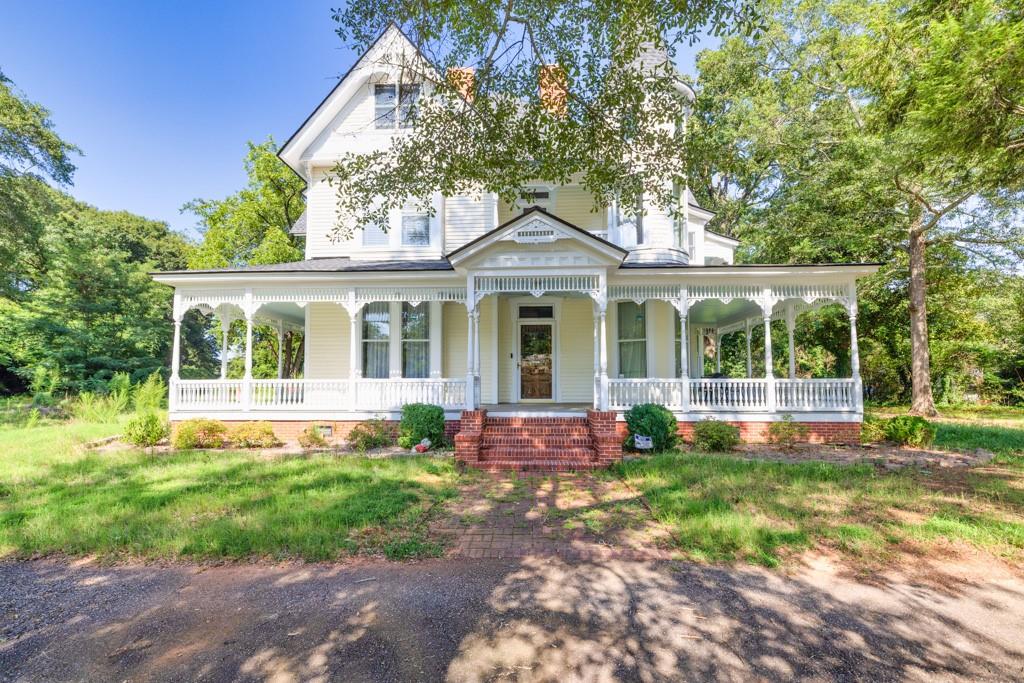 a front view of a house with yard and green space