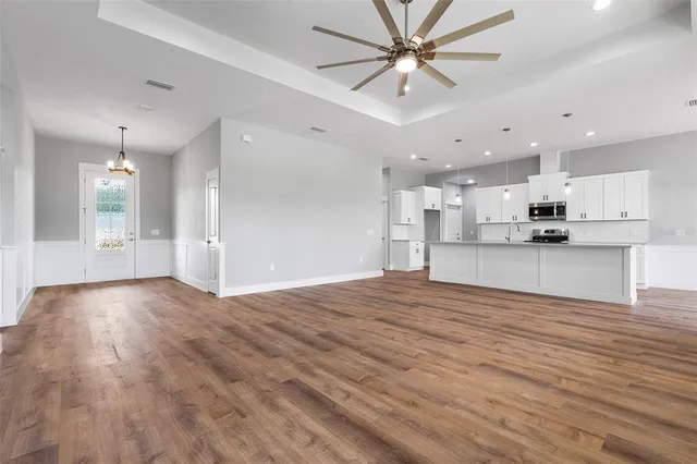 a view of a kitchen with a sink and a refrigerator