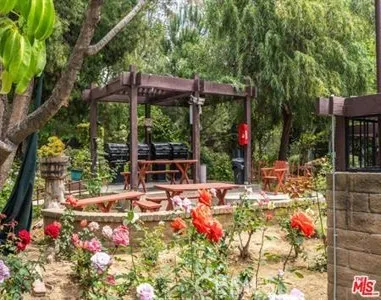 an aerial view of a house with a yard and garden