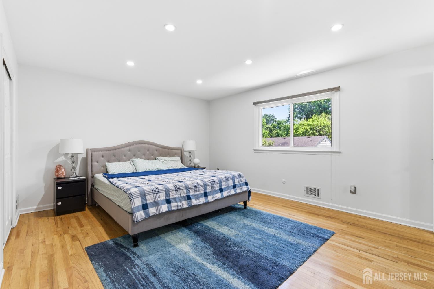 213 Normandy Road Edison, NJ 08820 - Photo 27 of 45 a bedroom with a bed and wooden floor