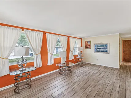 a view of a room with wooden floor and furniture