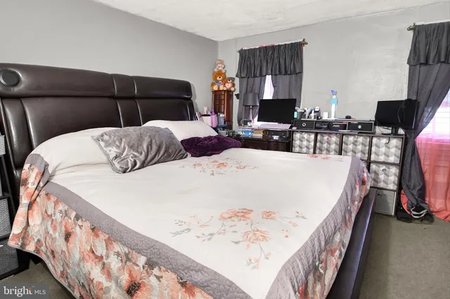 a bedroom with a bed and flat screen tv