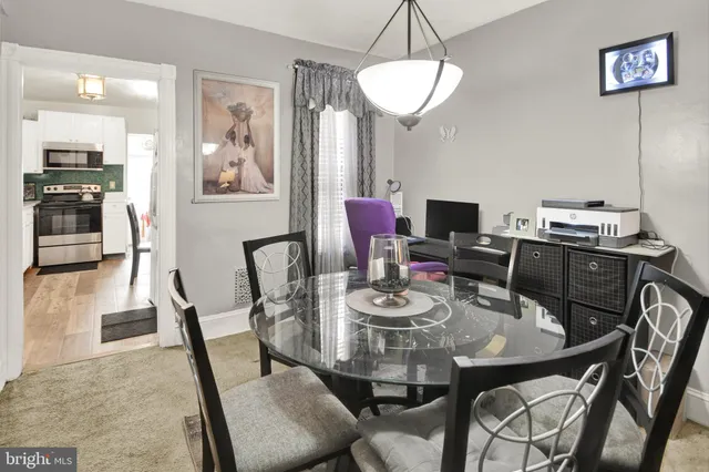 a view of a dining room with furniture and a chandelier