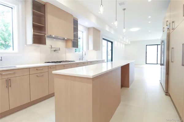 a kitchen with a sink a refrigerator and window