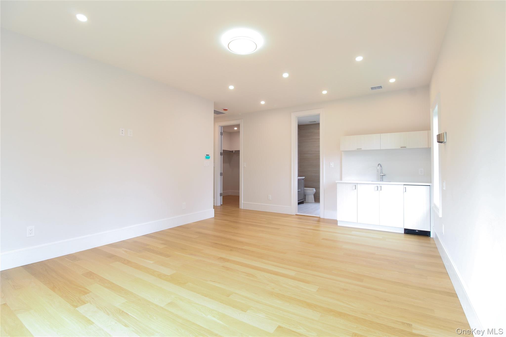 8 Sealy Drive Lawrence, NY 11559 - Photo 20 of 49 Unfurnished living room featuring recessed lighting and light wood-style flooring