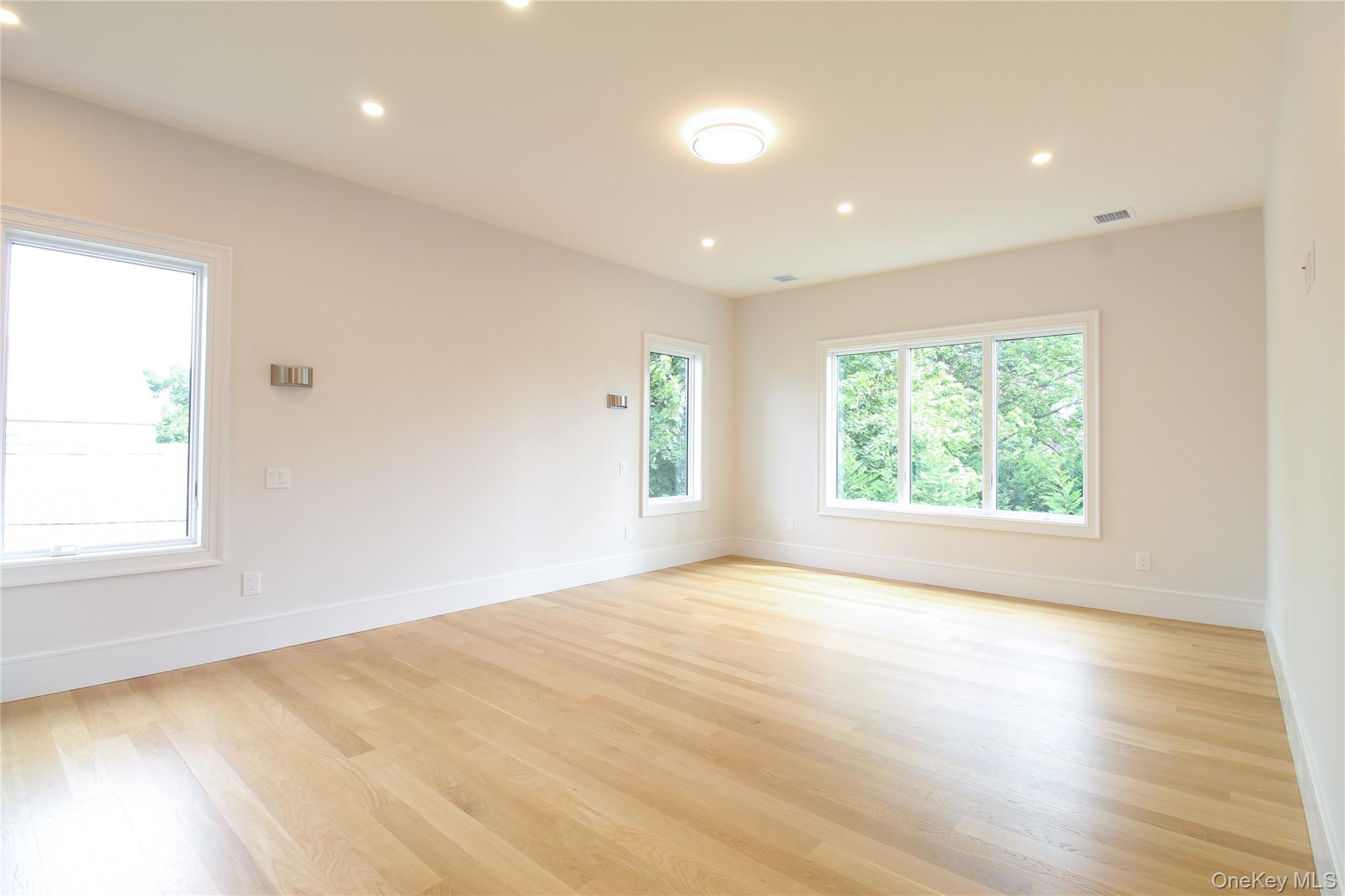 8 Sealy Drive Lawrence, NY 11559 - Photo 23 of 49 Unfurnished room featuring recessed lighting and light wood-style floors