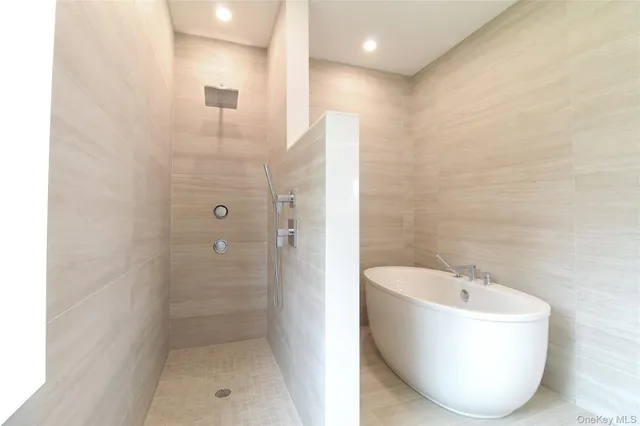 a bathroom with a bathtub and shower
