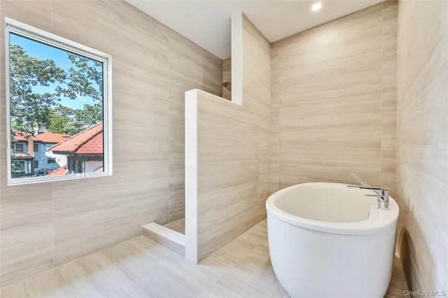 a bathroom with a bathtub and window