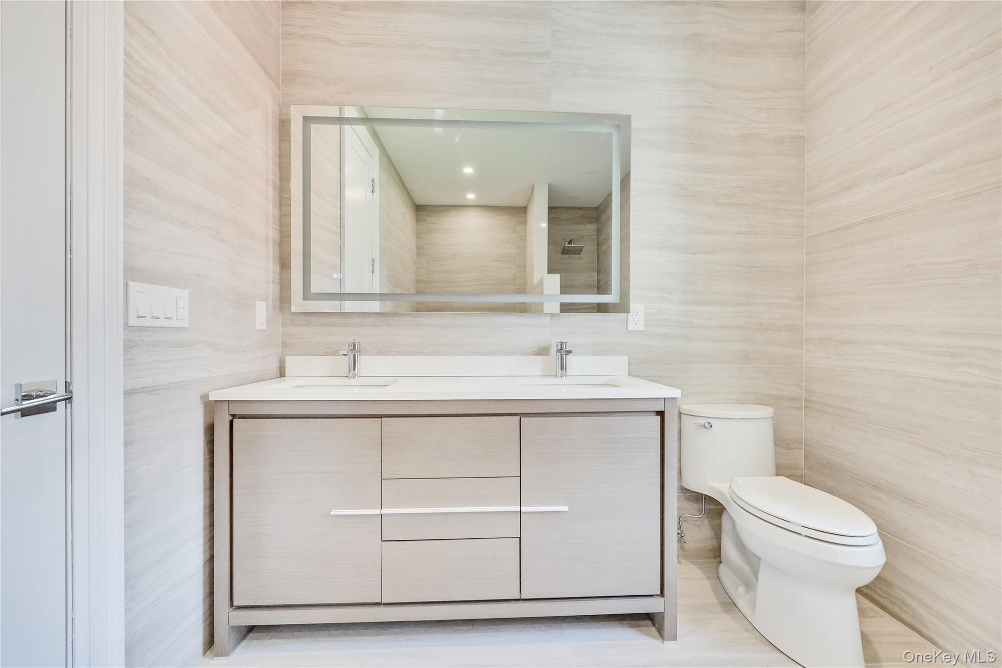 8 Sealy Drive Lawrence, NY 11559 - Photo 25 of 49 Bathroom with tile walls and double vanity