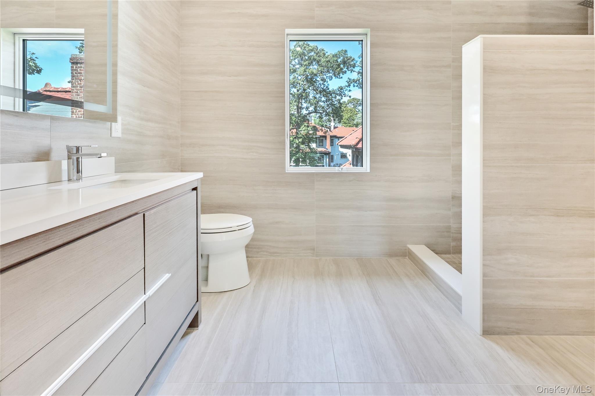 8 Sealy Drive Lawrence, NY 11559 - Photo 26 of 49 Bathroom featuring tile walls and vanity