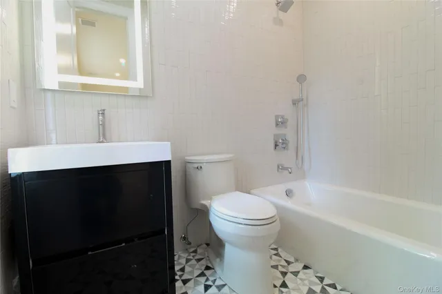 a bathroom with a sink toilet and bathtub