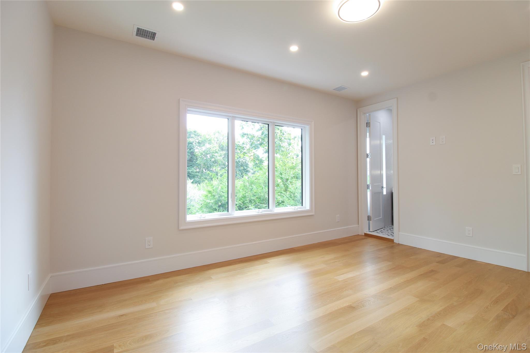 8 Sealy Drive Lawrence, NY 11559 - Photo 27 of 49 Unfurnished room with light wood-style flooring and recessed lighting