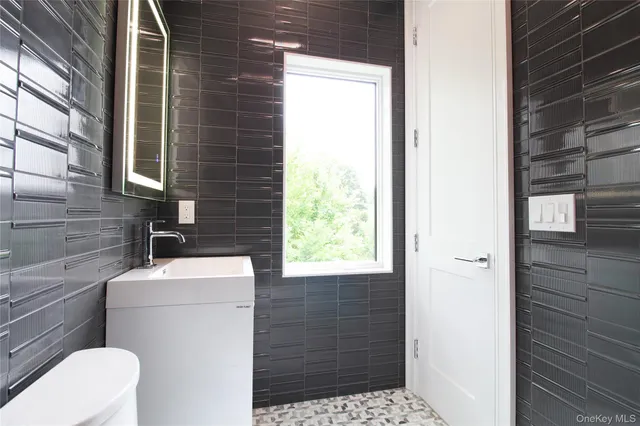 a bathroom with a sink a toilet and window