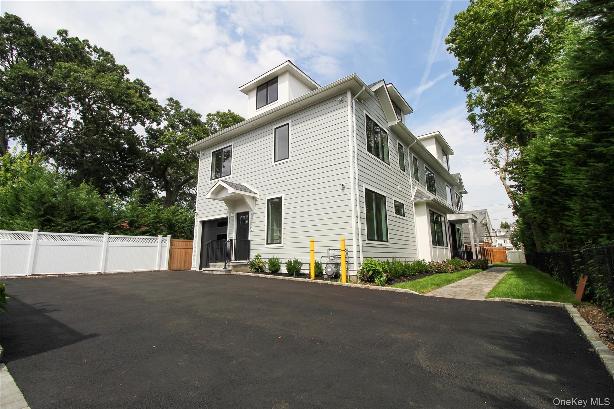 8 Sealy Drive Lawrence, NY 11559 - Photo 3 of 49 American foursquare style home featuring asphalt driveway