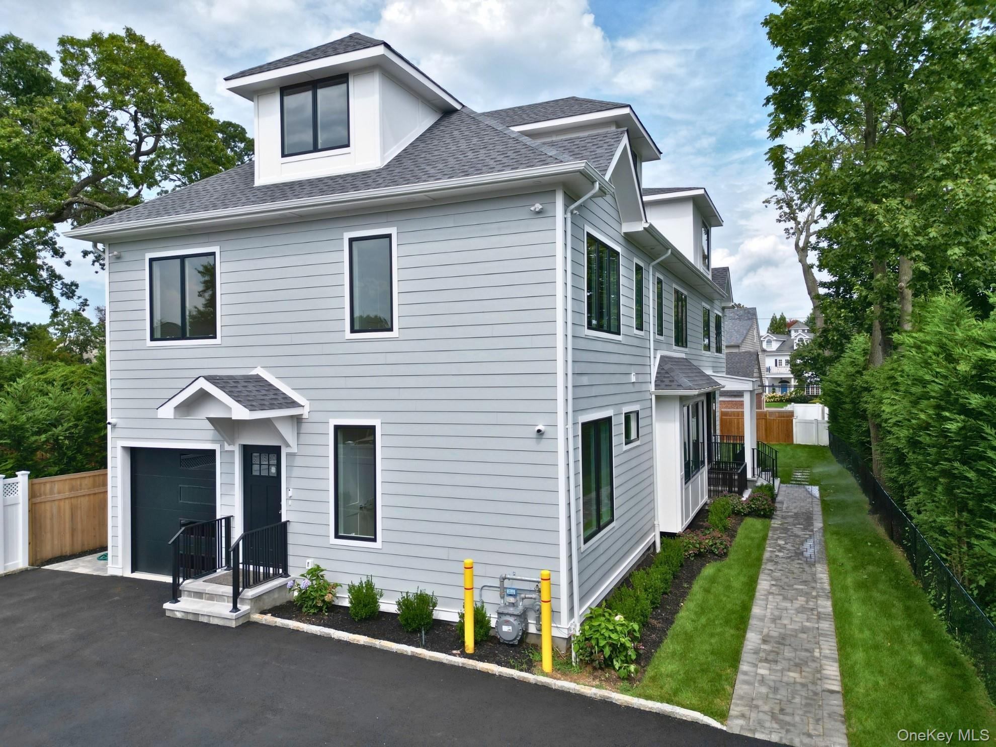 8 Sealy Drive Lawrence, NY 11559 - Photo 42 of 49 View of front of house with roof with shingles, a garage, and asphalt driveway