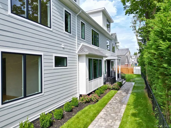 an aerial view of a house with a garden and trees