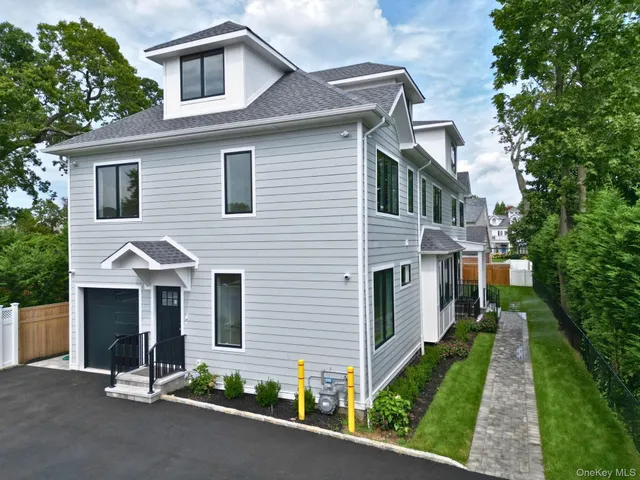 a view of a house with a yard and flower plants