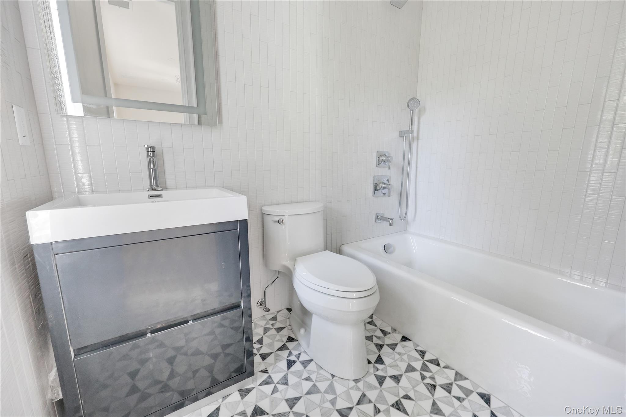 8 Sealy Drive Lawrence, NY 11559 - Photo 46 of 49 Bathroom with tile walls, shower / washtub combination, and vanity