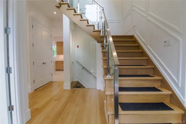 a view of entryway and hall with wooden floor