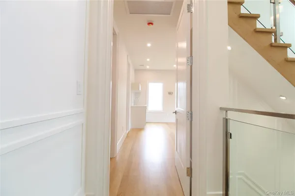 a view of a hallway with wooden floor