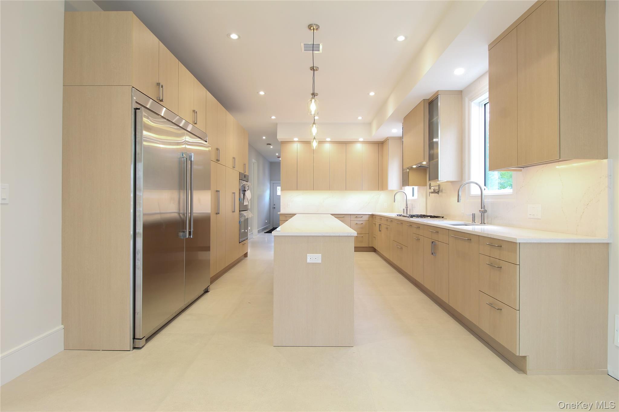 8 Sealy Drive Lawrence, NY 11559 - Photo 10 of 49 Kitchen with light brown cabinets, built in fridge, modern cabinets, a center island, and recessed lighting
