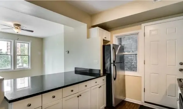 a kitchen with stainless steel appliances granite countertop a refrigerator and a sink