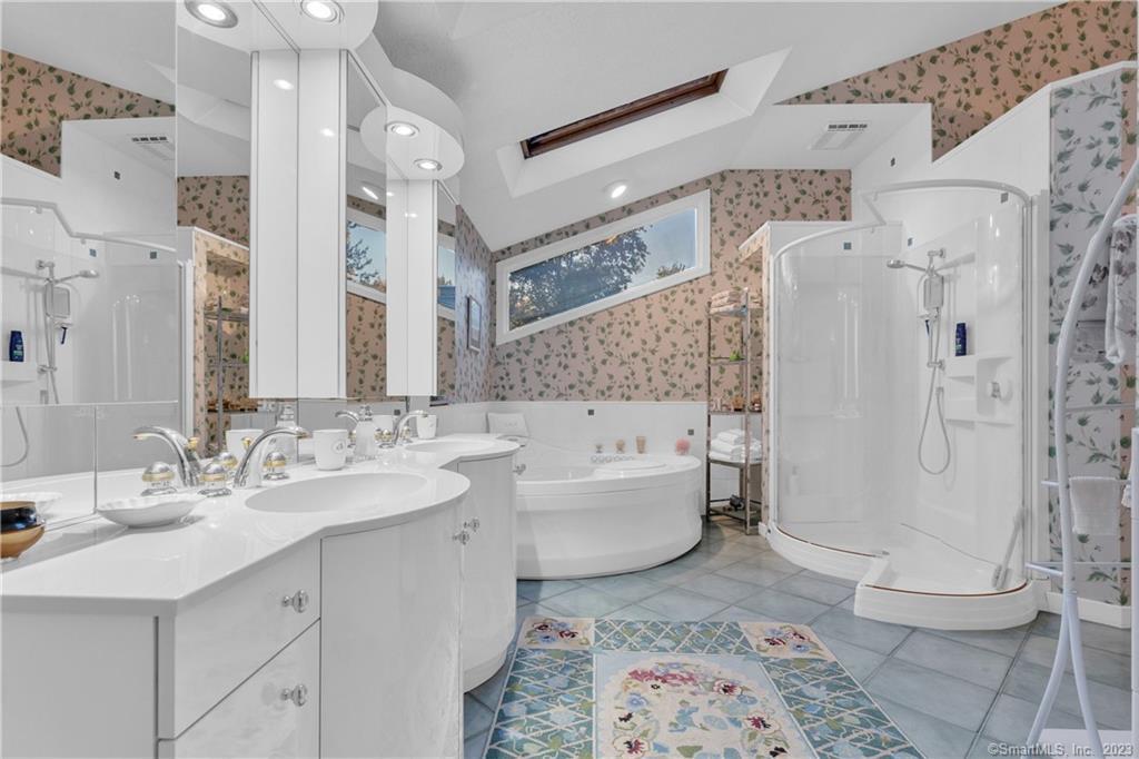 940 Durham Road Wallingford, CT 06492 - Photo 25 of 40 The Primary Bathroom has Double Sinks & Skylights, along with a Walk-in Closet.