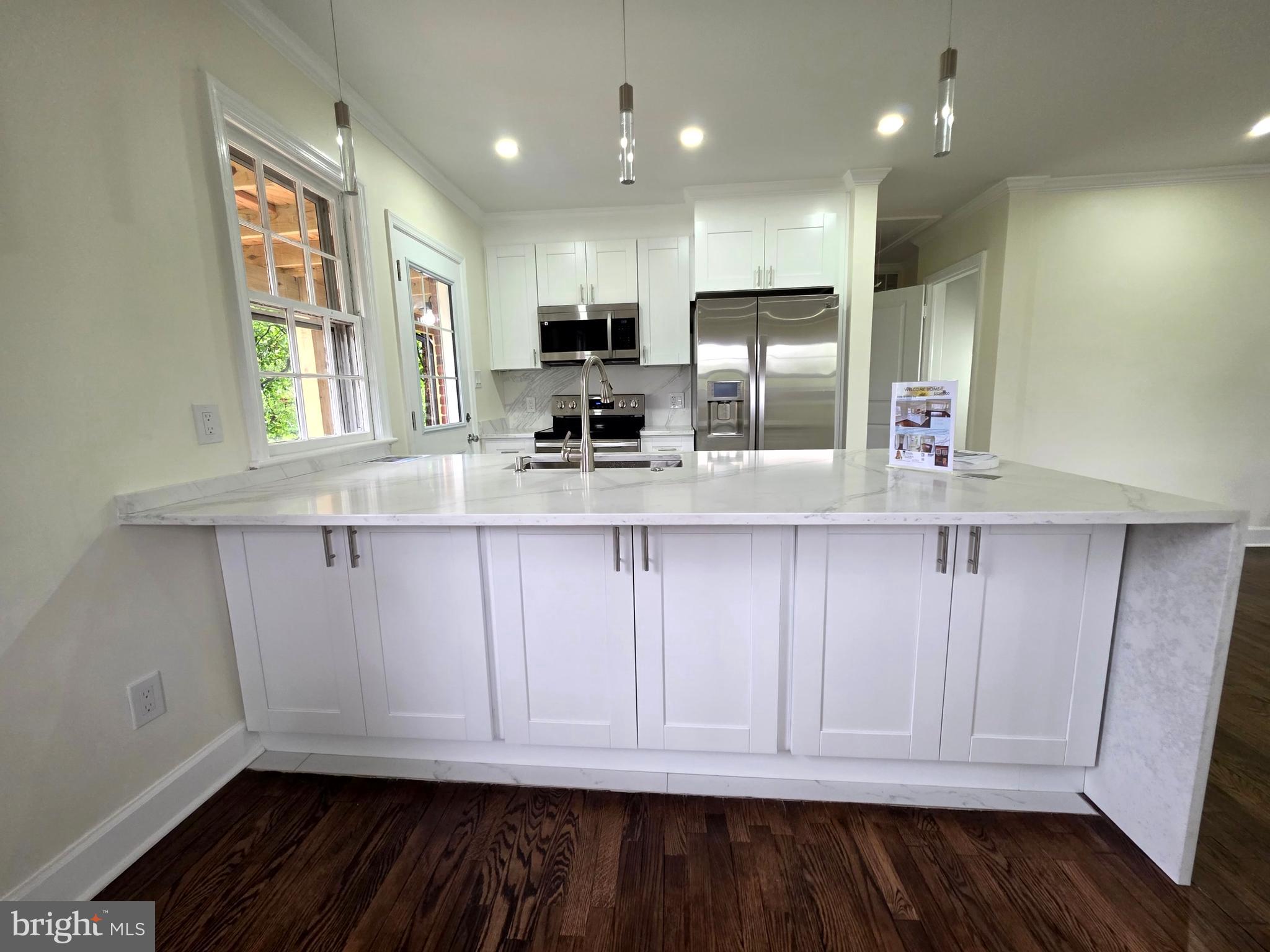 2206 Brinkley Road Fort Washington, MD 20744 - Photo 45 of 78 a kitchen with granite countertop white cabinets and stainless steel appliances