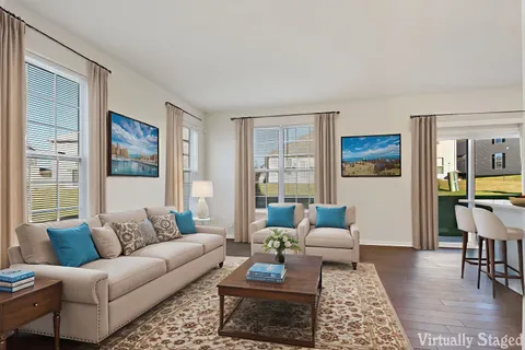 a living room with furniture or couch and a wooden floor