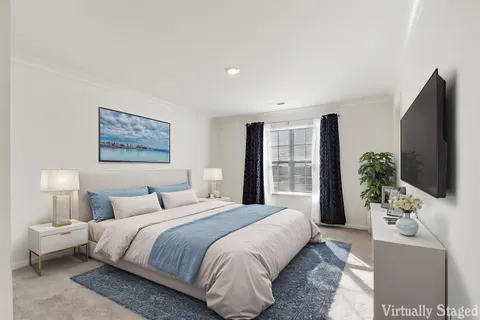 a bedroom with a large bed and a flat screen television