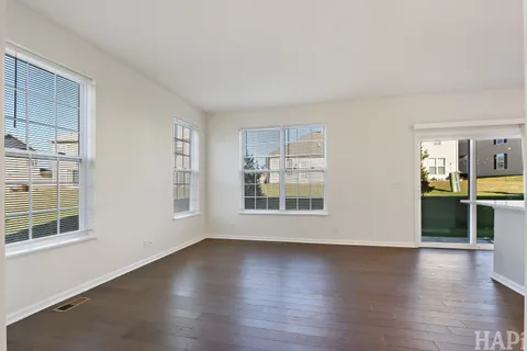 a view of wooden floor and windows in a room