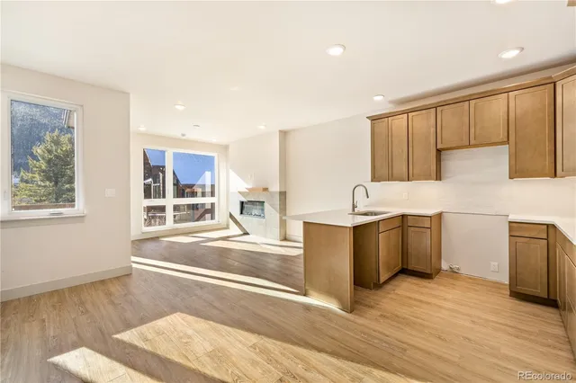 a large kitchen with kitchen island a sink wooden floor and counter space