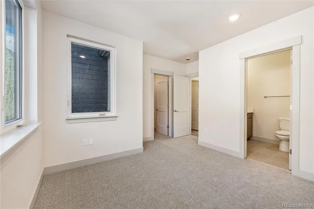 a view of empty room with a bathroom