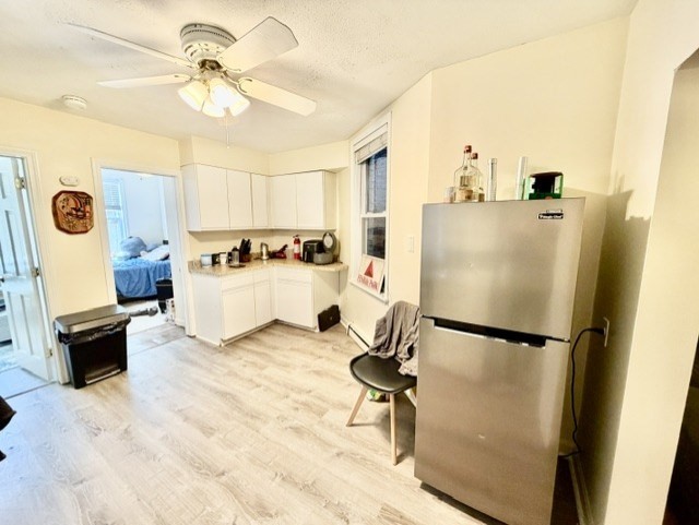 14 Cleveland Place, Unit 2 Boston, MA 02113 - Photo 2 of 18 a view of a kitchen with a refrigerator a microwave and a dining table