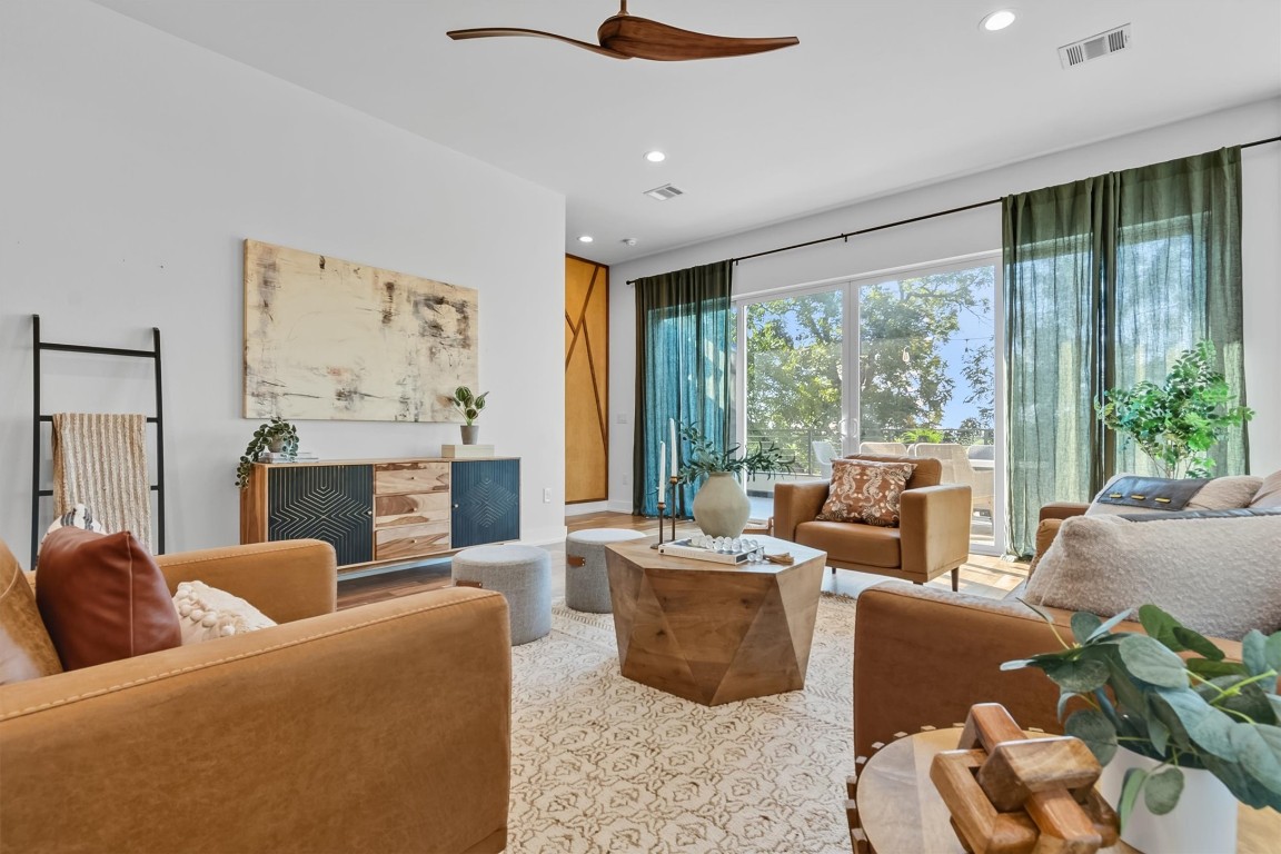 2712 Oak Springs Drive, Unit A Austin, TX 78702 - Photo 12 of 34 a living room with furniture large windows and a fireplace