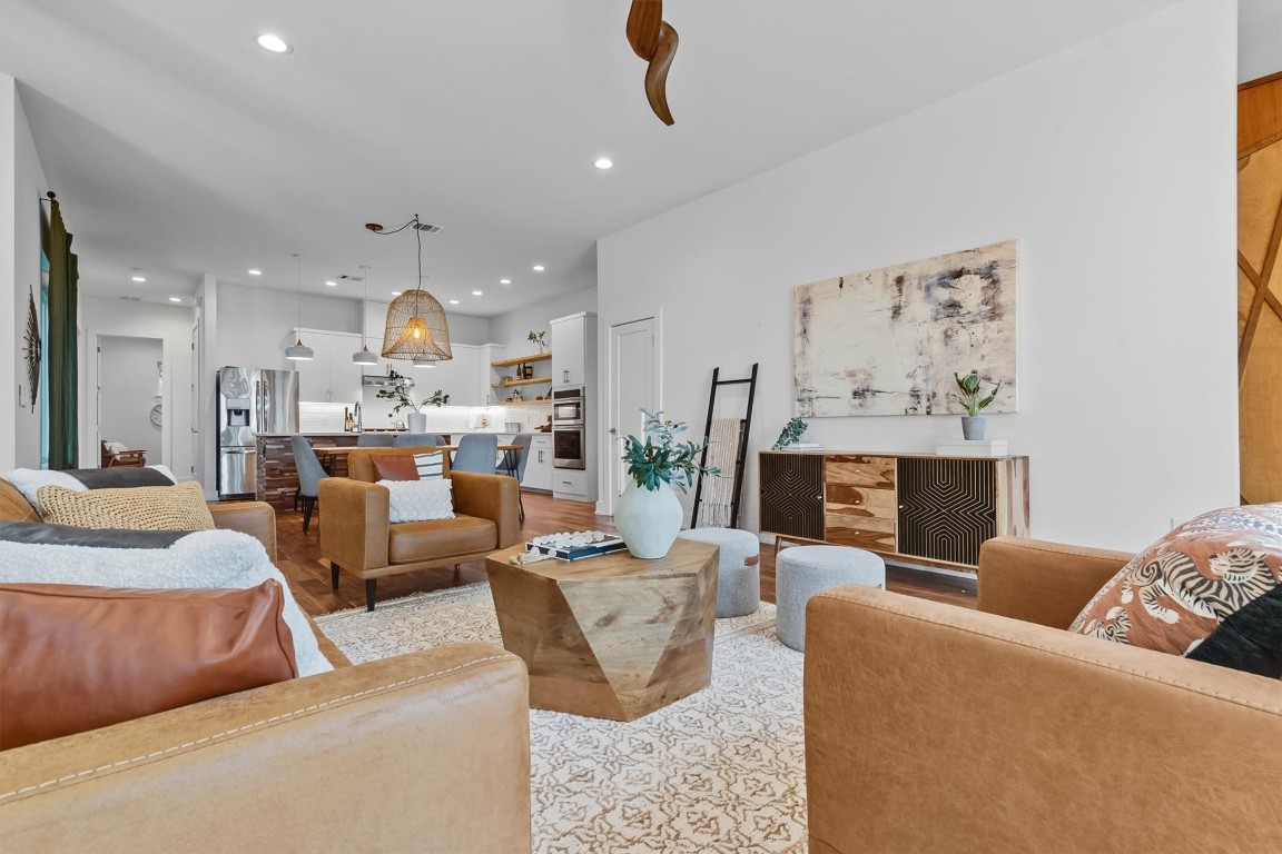 2712 Oak Springs Drive, Unit A Austin, TX 78702 - Photo 13 of 34 a living room with fireplace furniture and a chandelier