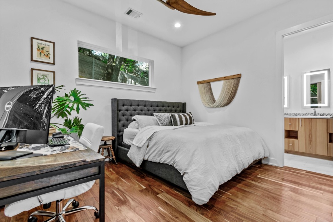 2712 Oak Springs Drive, Unit A Austin, TX 78702 - Photo 16 of 34 a bedroom with a bed and a potted plant