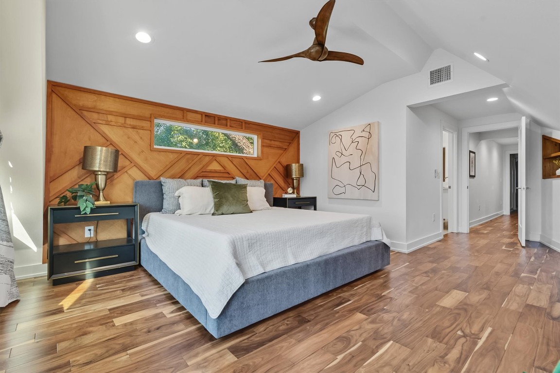 2712 Oak Springs Drive, Unit A Austin, TX 78702 - Photo 19 of 34 a bedroom with a large bed and a chandelier