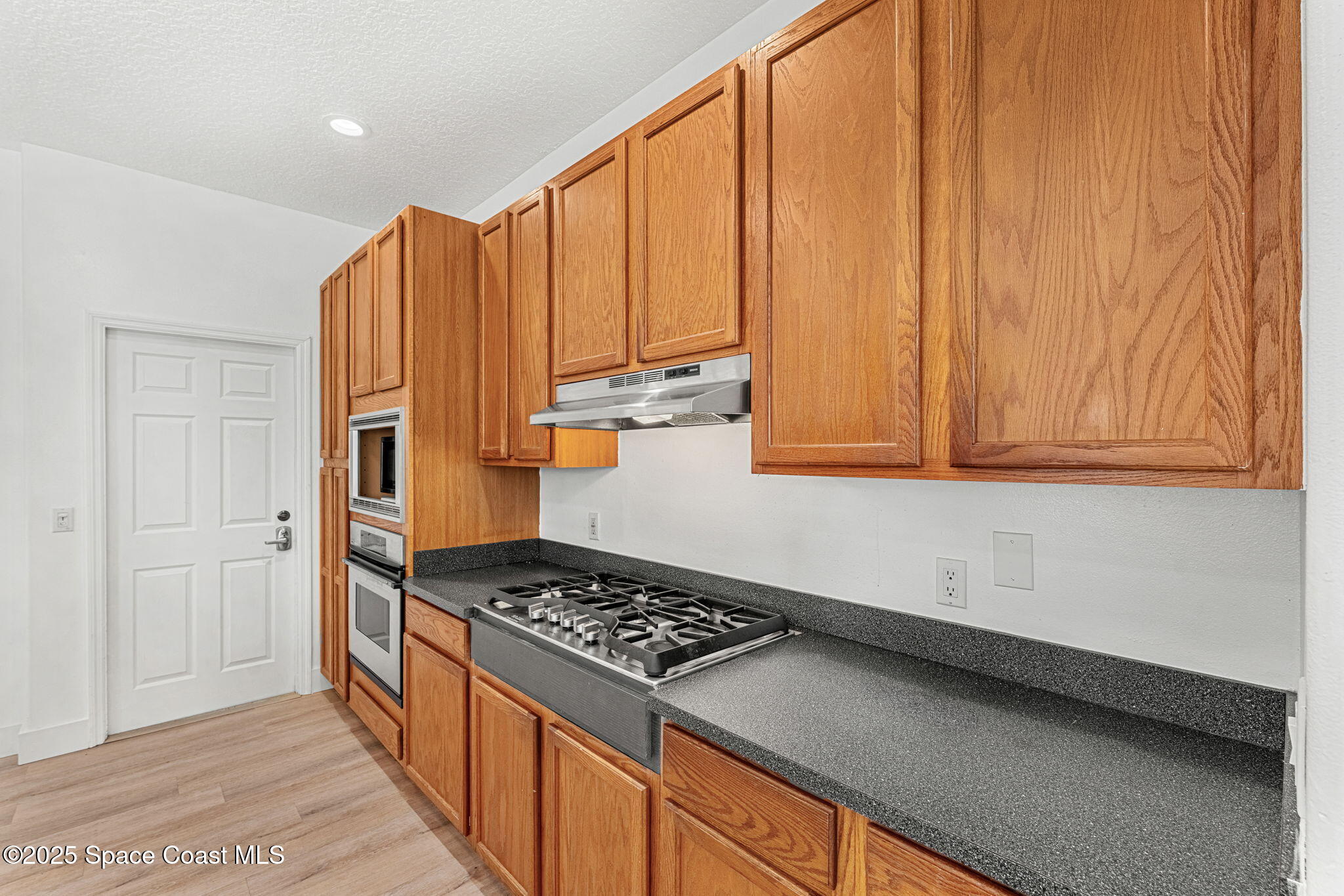 48 Harbor Circle Cocoa Beach, FL 32931 - Photo 11 of 48 a kitchen with stainless steel appliances granite countertop a refrigerator and a stove