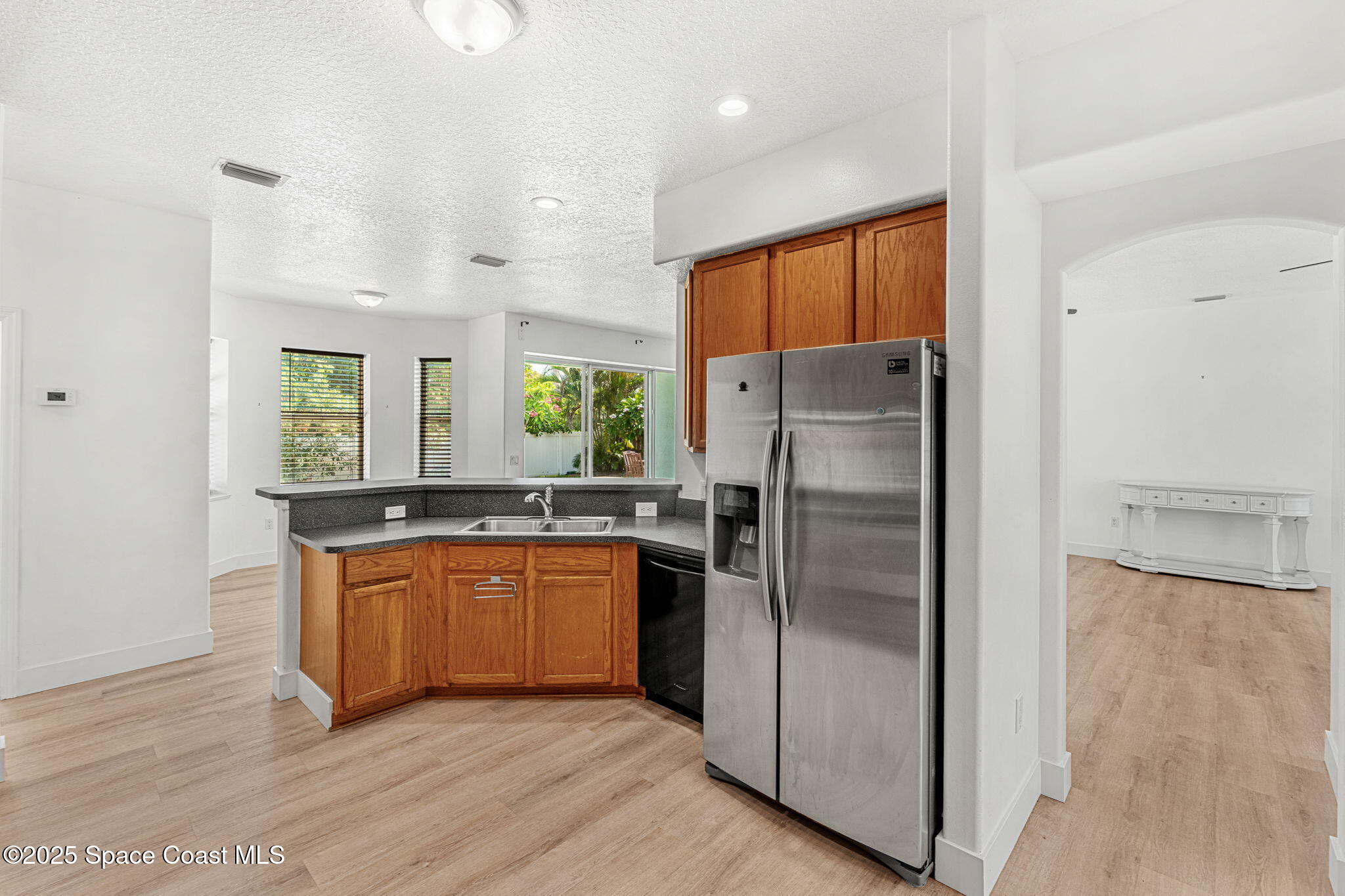 48 Harbor Circle Cocoa Beach, FL 32931 - Photo 12 of 48 a kitchen with stainless steel appliances granite countertop a refrigerator a sink and a stove