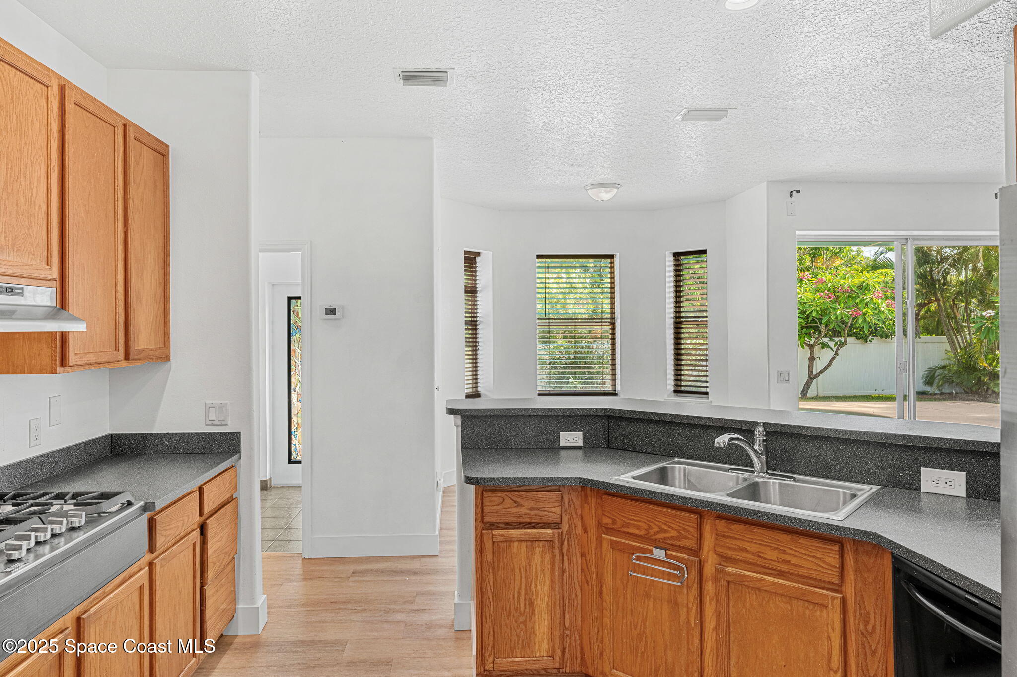 48 Harbor Circle Cocoa Beach, FL 32931 - Photo 13 of 48 a kitchen with stainless steel appliances granite countertop a sink a stove and a refrigerator