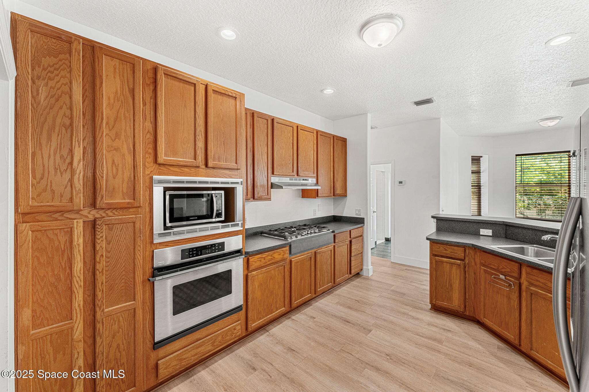 48 Harbor Circle Cocoa Beach, FL 32931 - Photo 14 of 48 a kitchen with stainless steel appliances granite countertop a stove a sink and a refrigerator
