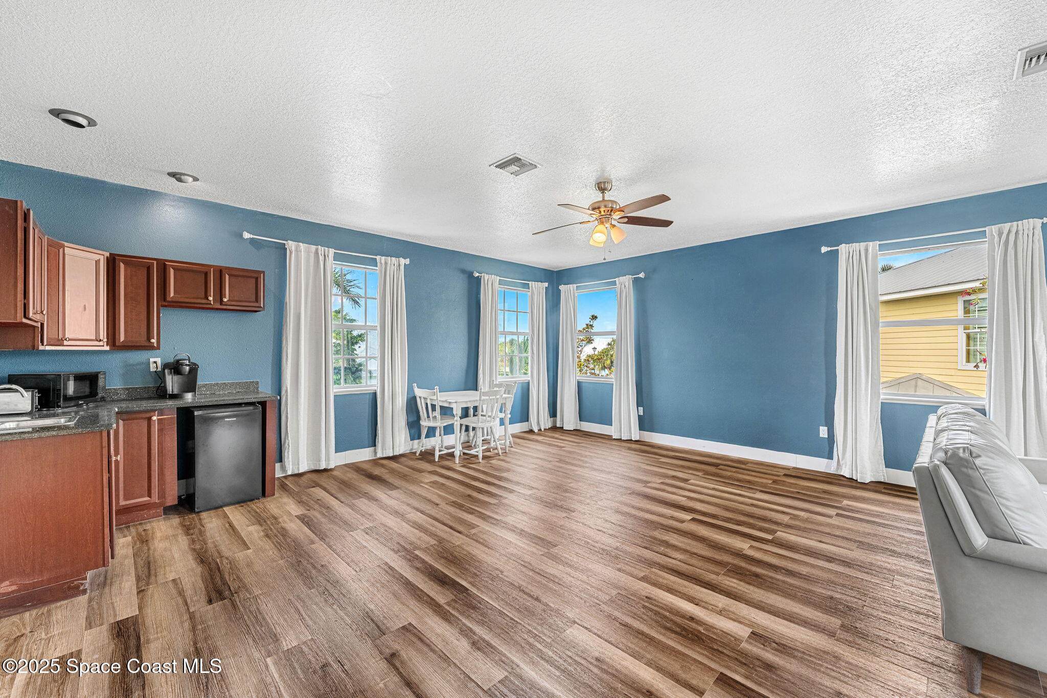 48 Harbor Circle Cocoa Beach, FL 32931 - Photo 15 of 48 a view of a livingroom with furniture window and wooden floor