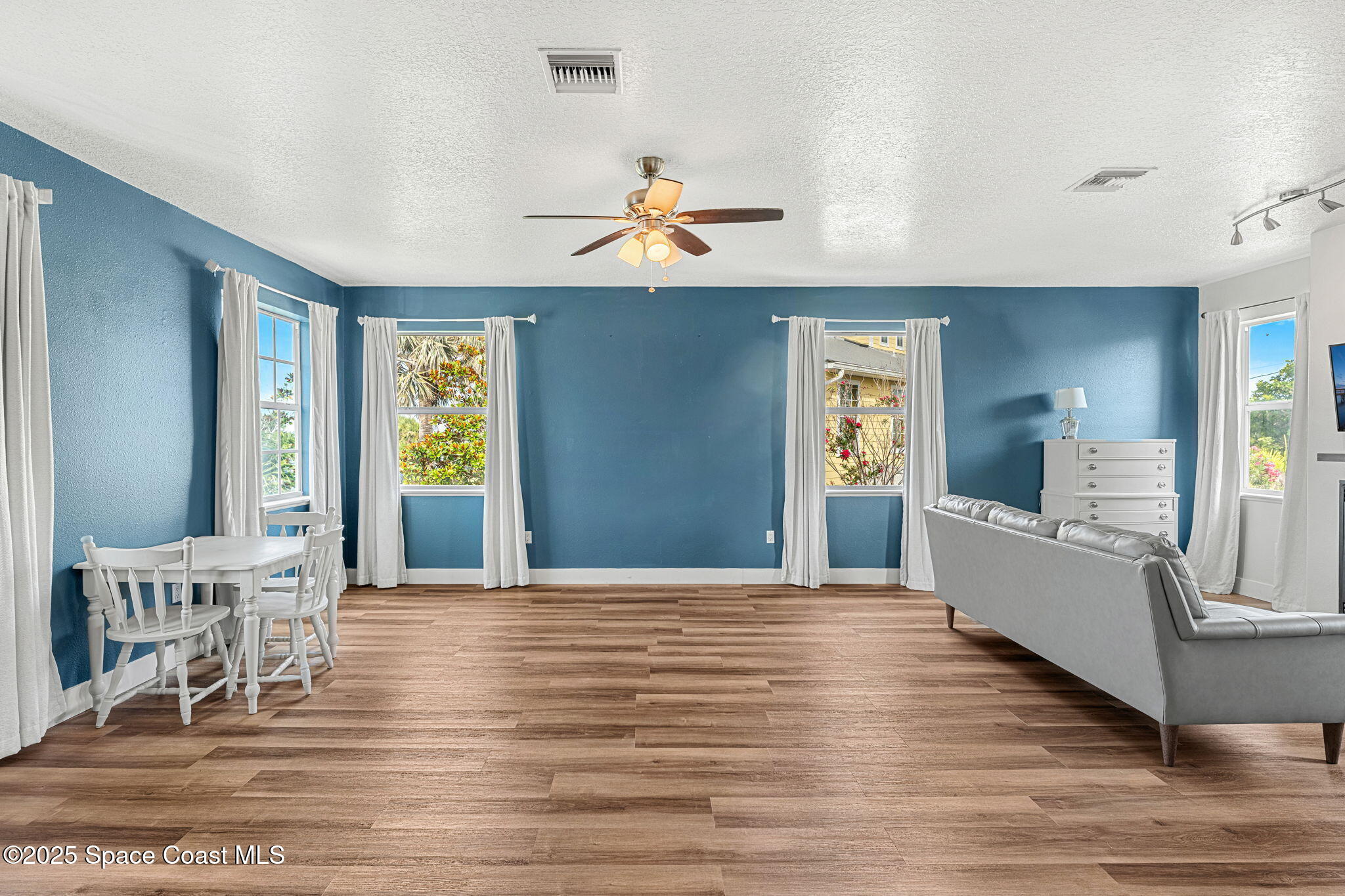 48 Harbor Circle Cocoa Beach, FL 32931 - Photo 16 of 48 a view of a livingroom with furniture wooden floor and windows